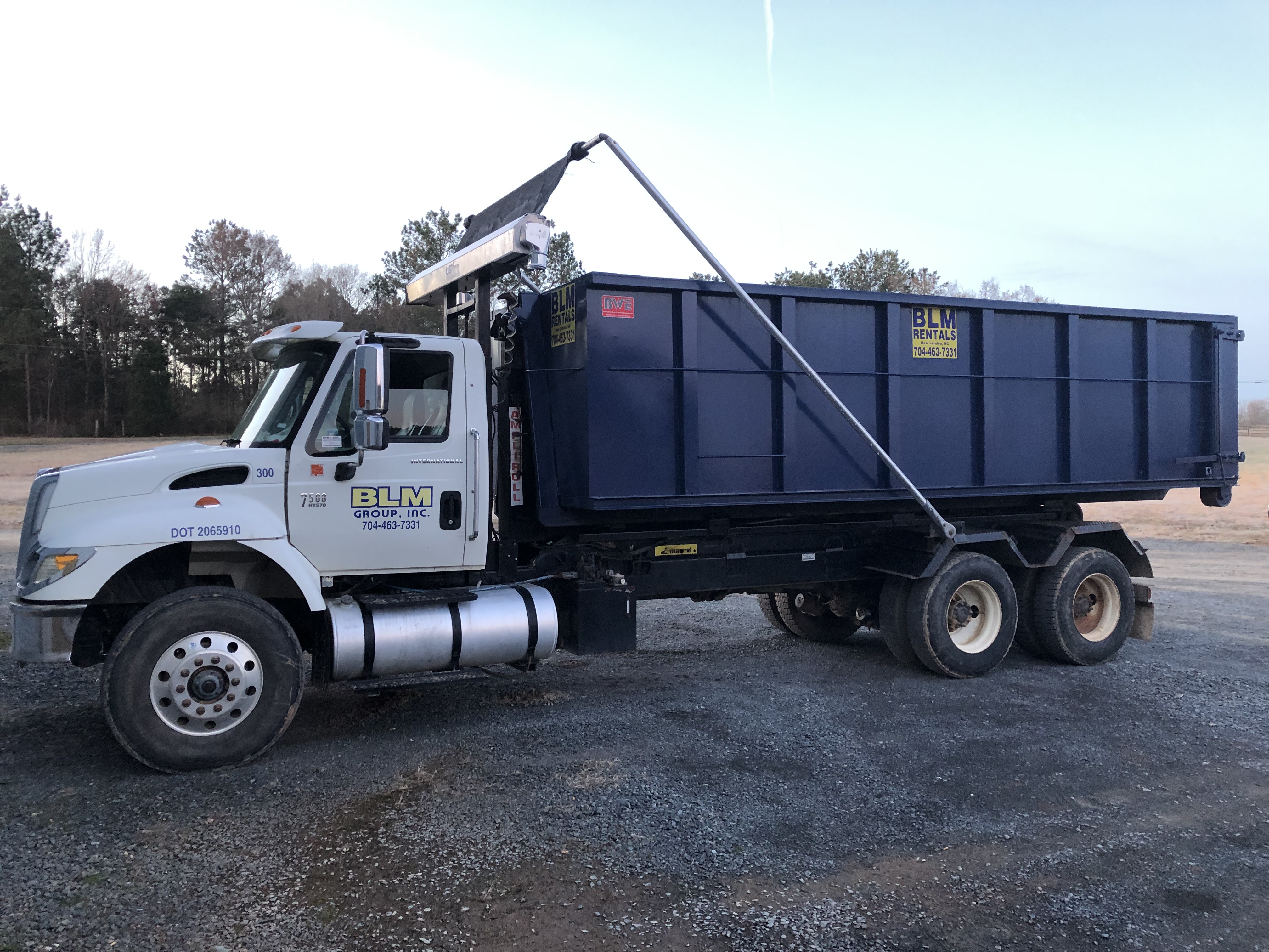 BLM Rental truck carrying a construction dumpster